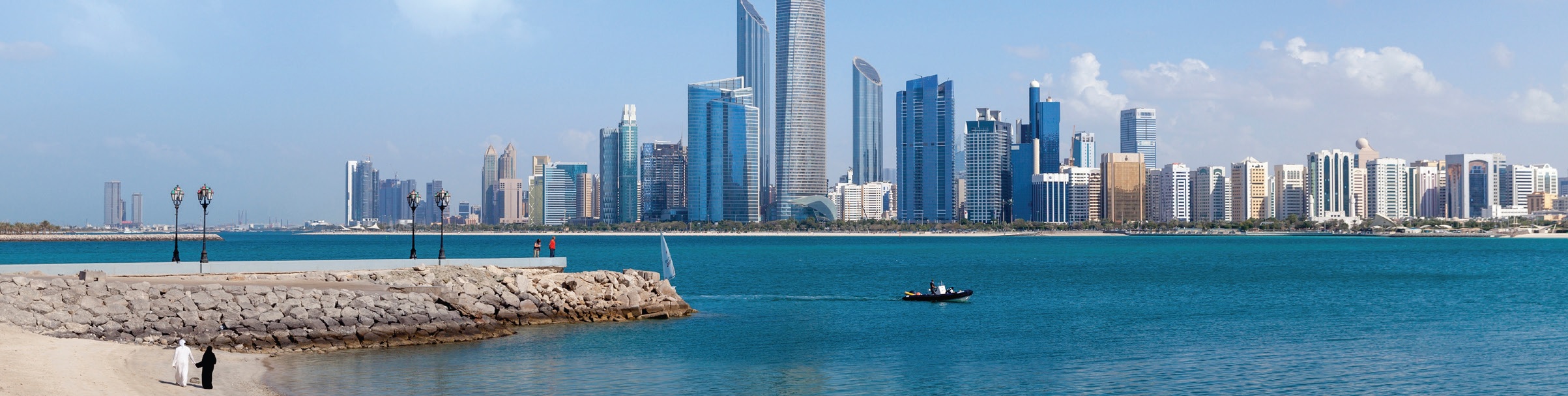 A scenic view of Abu Dhabi waterfont with the city in the background.